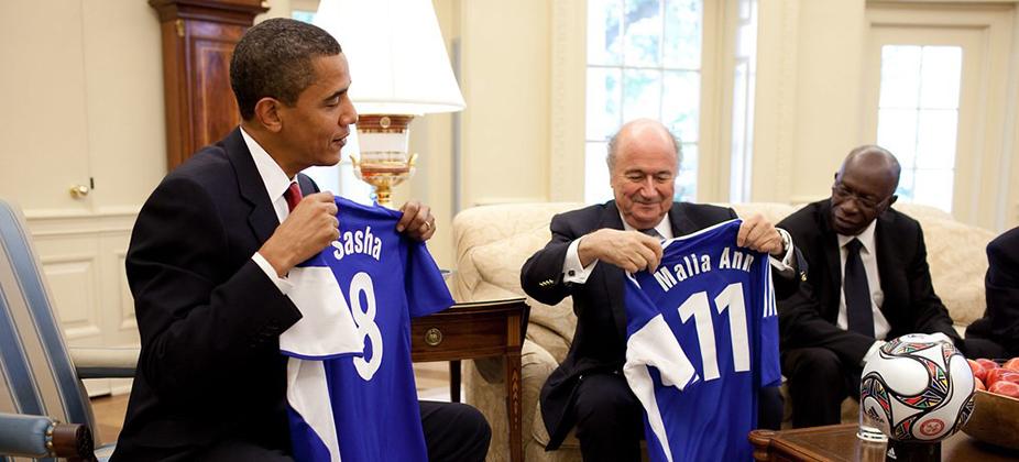 President Obama is presented with soccer jerseys for his daughters, Sasha and Malia, by FIFA President Joseph Blatter
