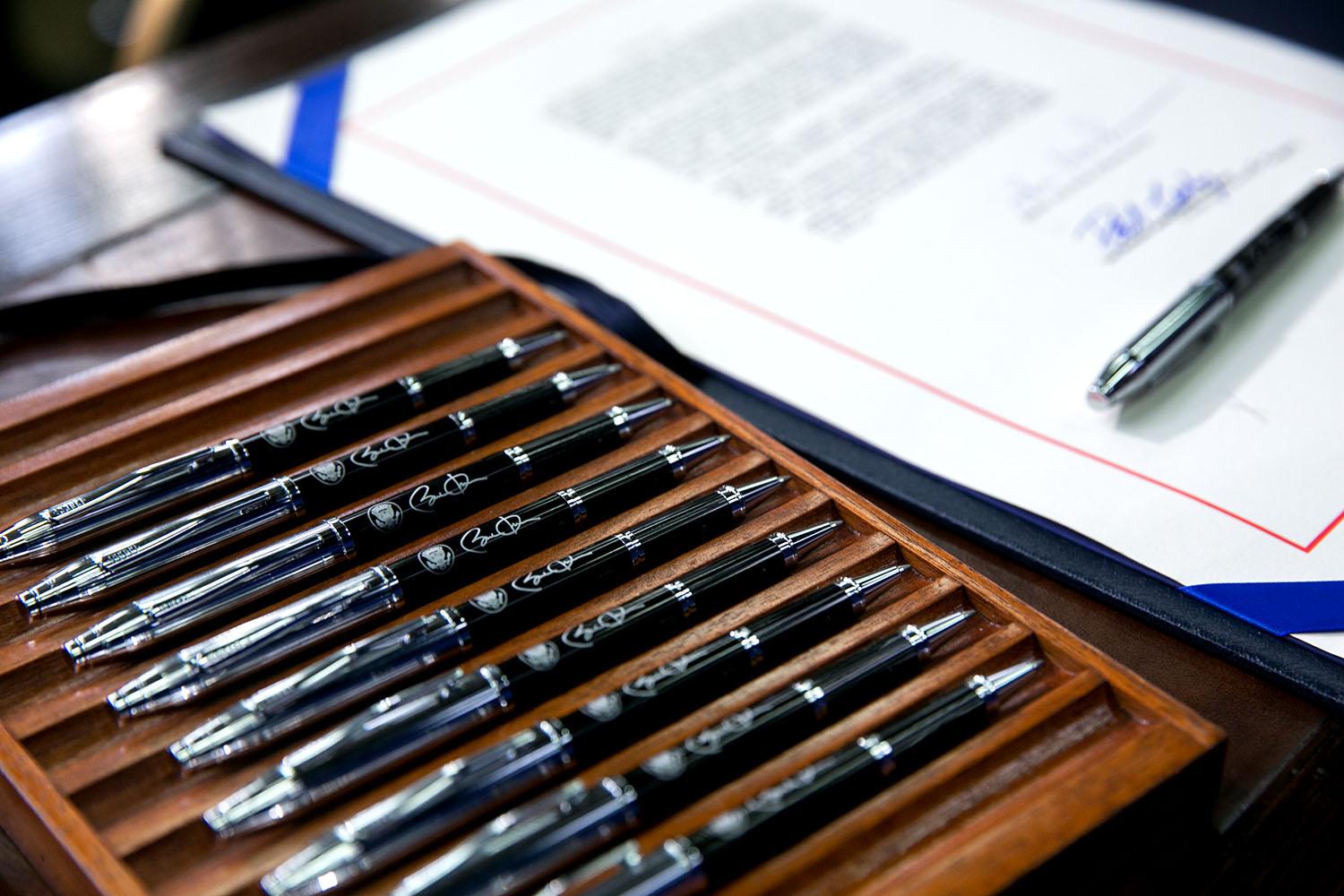 Pens to be used by President Barack Obama are set on the signing table with the bill before signing
