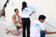 Image courtesy of the Barack Obama Presidential Library, First Lady Michelle Obama helps paint …