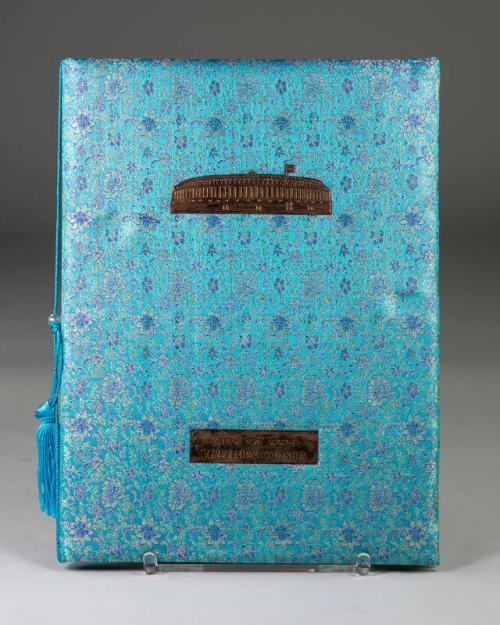 Portfolio Wrapped in Blue Cloth with a Floral Pattern