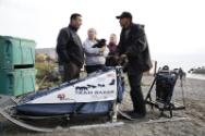Image courtesy of the Barack Obama Presidential Library, President Barack Obama hops on a sled …