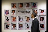 Image courtesy of the Barack Obama Presidential Library, President Barack Obama looks at a disp…