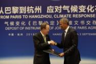 Image courtesy of the Barack Obama Presidential Library, President Barack Obama hands the Paris…